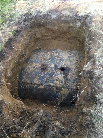Dig down and expose top of oil tank.